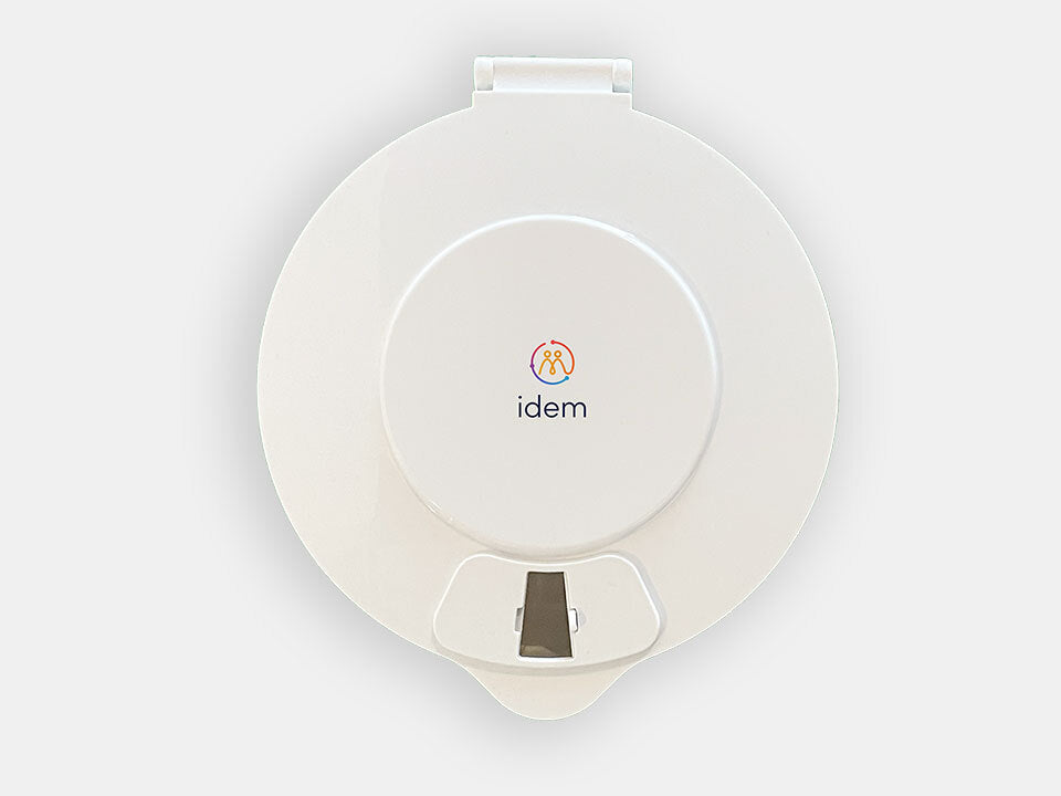 The Idem pill dispenser with a white lid facing front