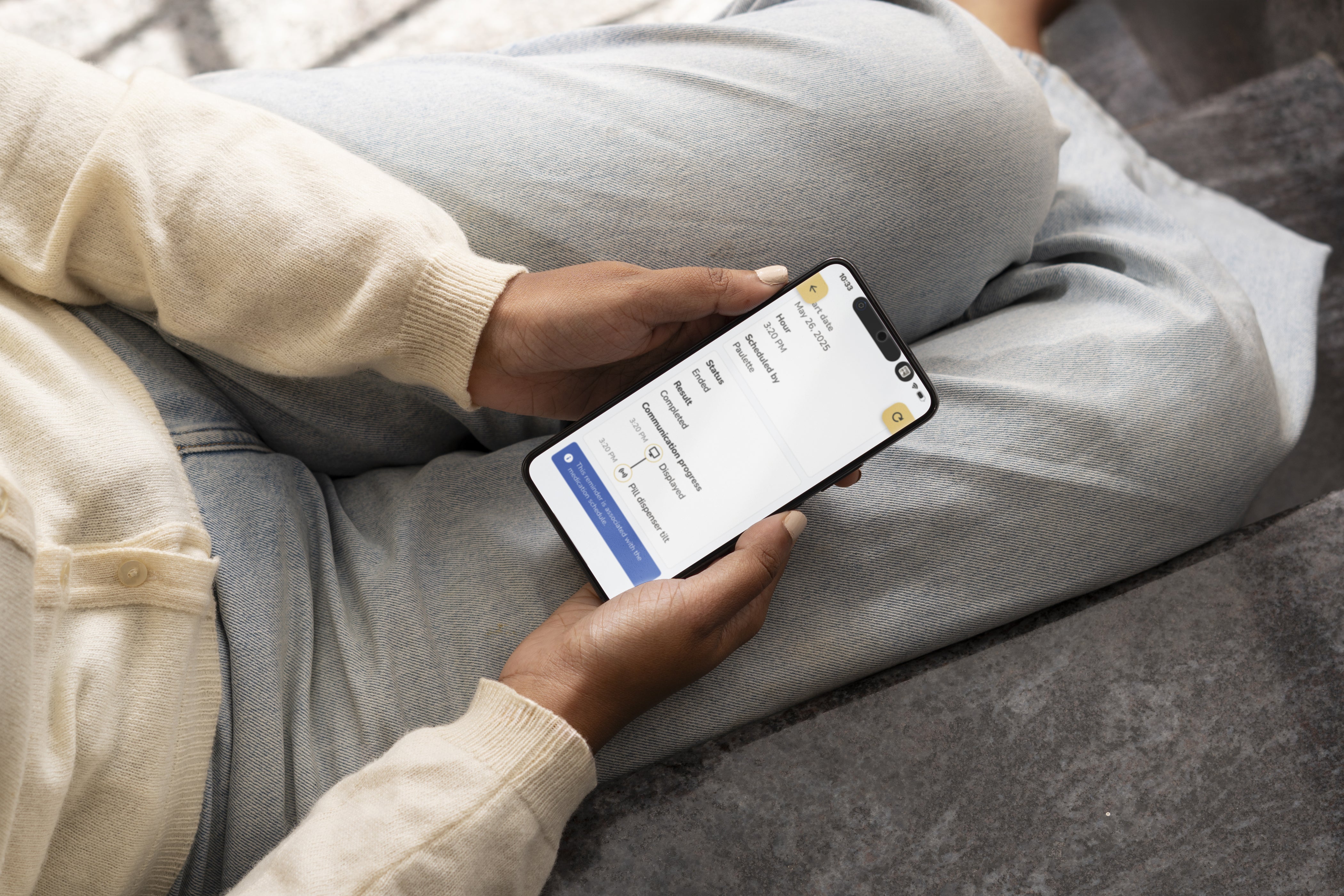 Caregiver holding their phone with the Idem Caregiver app opened