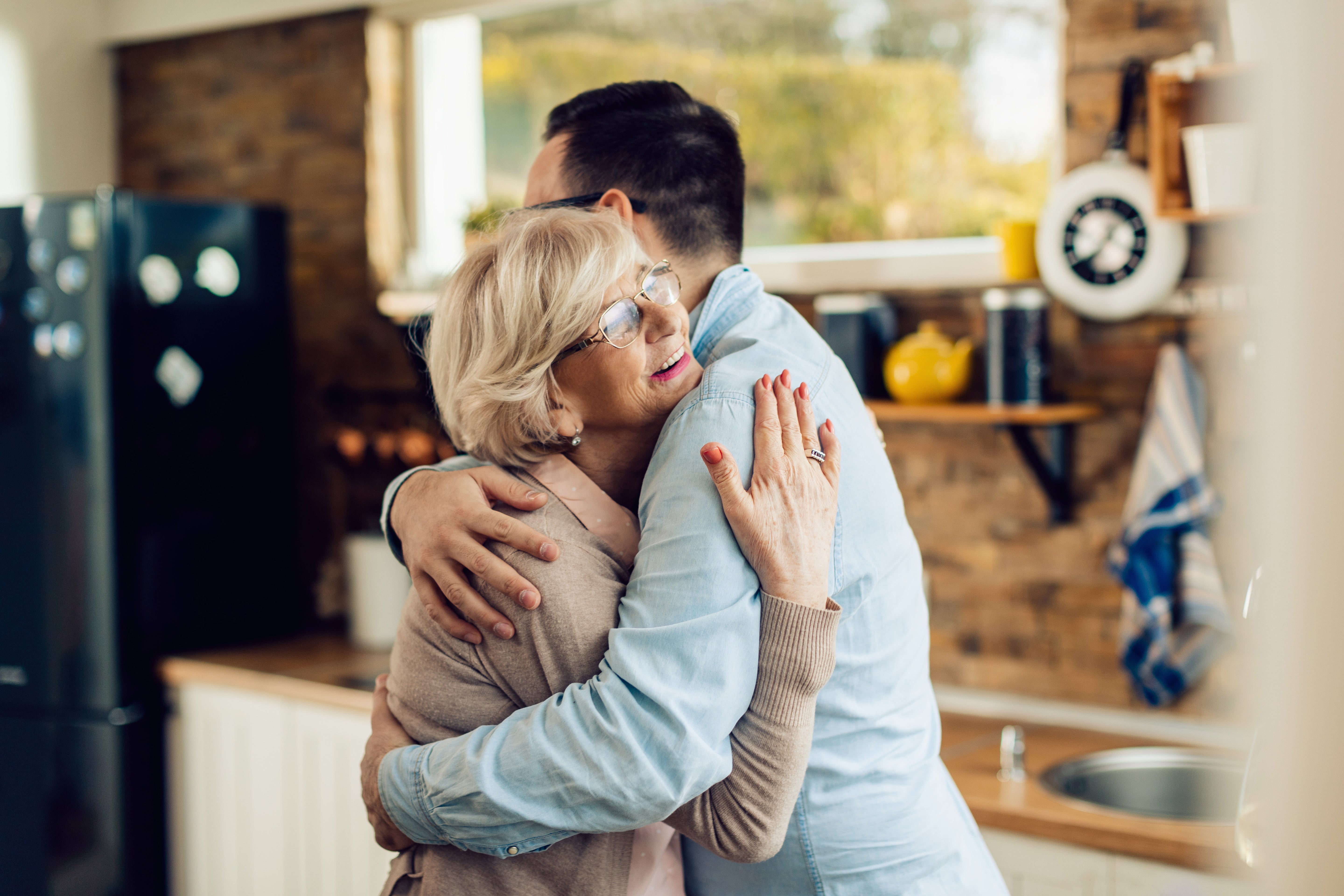 Man and woman embracing in a kitchen