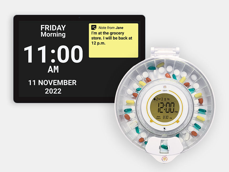 Idem Digital clock with Idem pill organizer displaying time and date on a white background