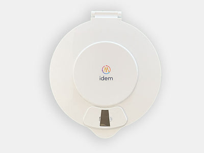 The Idem pill dispenser with a white lid facing front 