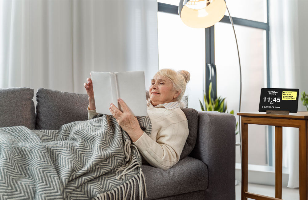 A woman reading on a couch with the Idem clock next to her